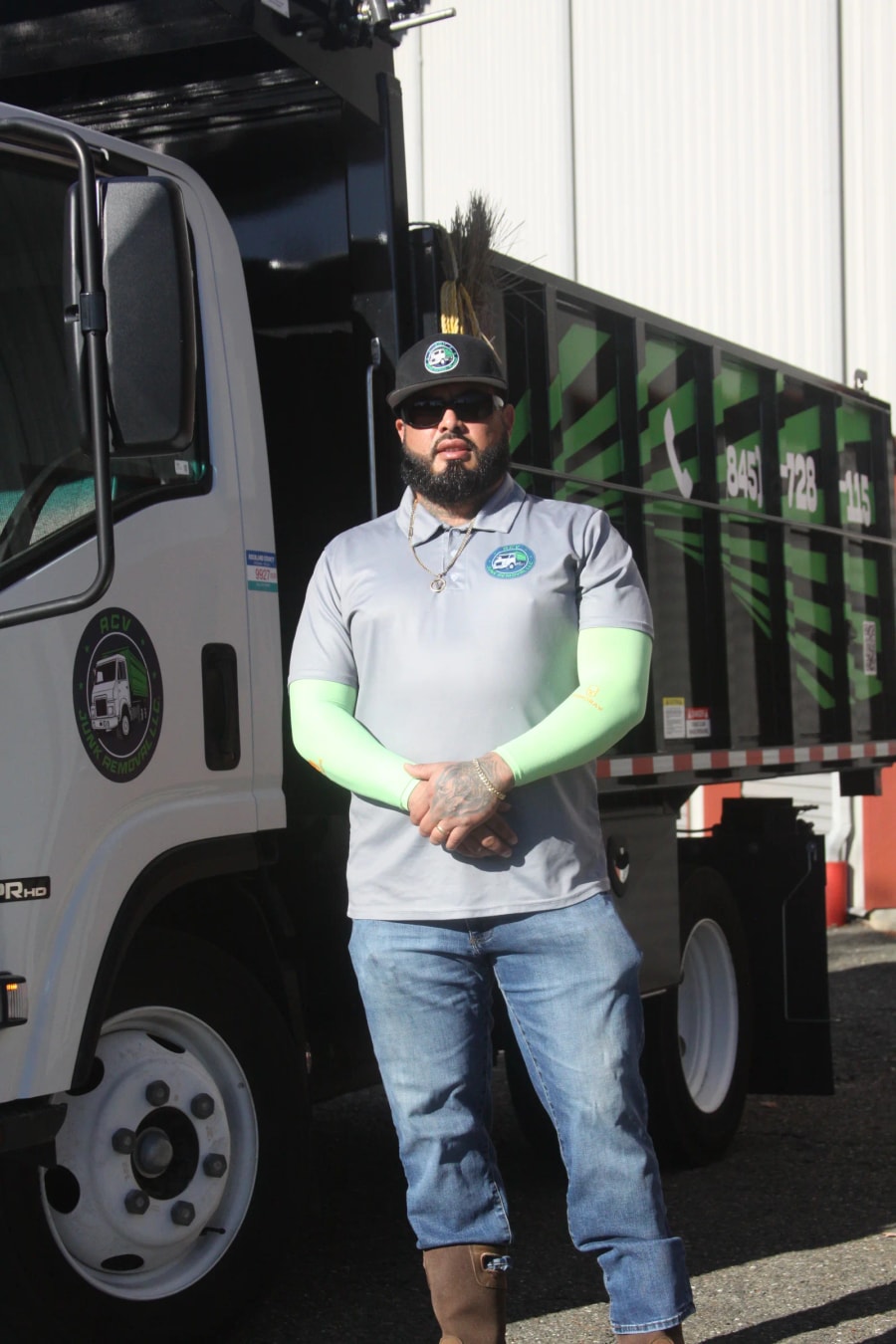 Andy Vila standing with an ACV Junk Removal truck